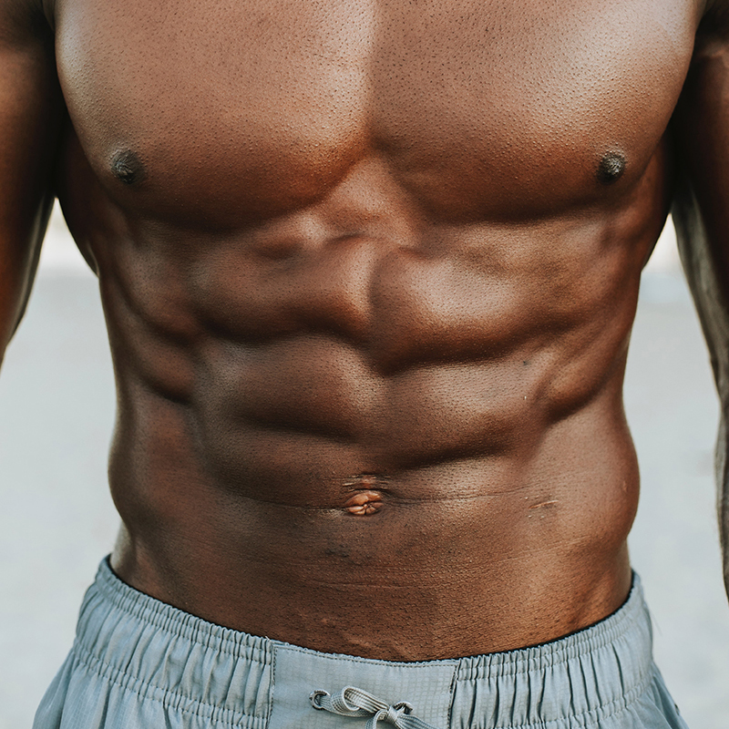 Close-up of black man's chest and six-pack abs